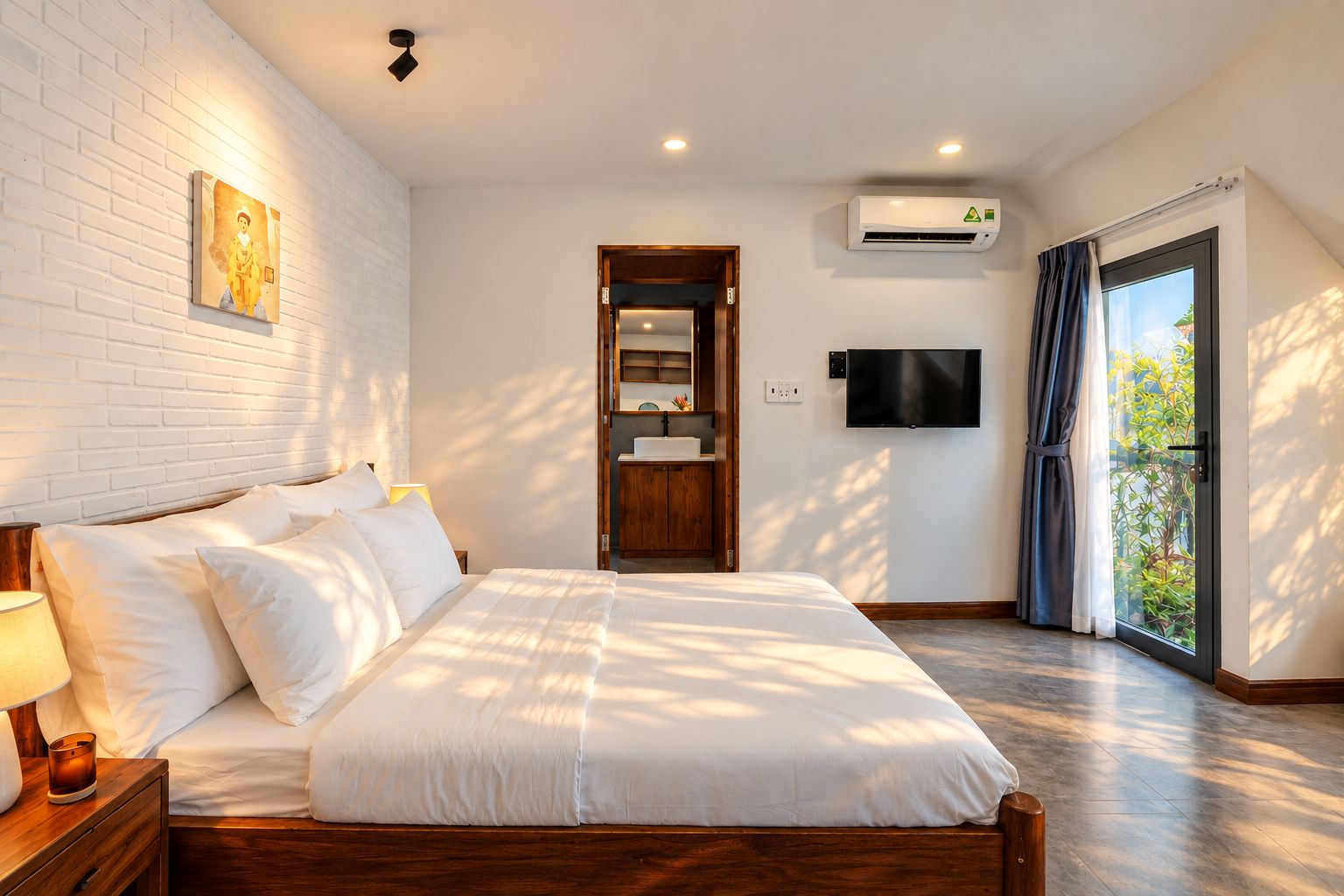 A hotel room with a large bed, a flat-screen TV, an air conditioning unit, a wooden cabinet, and a sliding glass door to the outside.