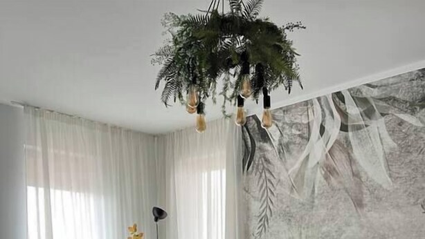A modern living room with a sectional sofa, a dining table with chairs, and a large window with sheer curtains. - Scandiland Apartment (Brașov)