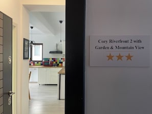 A sign indicating 'Cozy Riverfront 2 with Garden & Mountain View.'