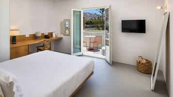 A bedroom with a bed, a desk, a chair, a TV, and a balcony with a view.