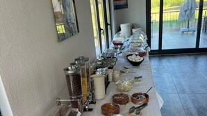 A buffet setup with various food items and utensils. - Tolstoy’un Bisikleti Gökçeada (Gökçeada)