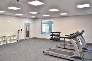 A fitness room with treadmills, dumbbells, and a water dispenser. - Mainstay Suites Gatlinburg TN (Gatlinburg)