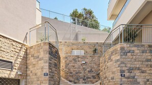 A set of concrete stairs leading to a building entrance, with stone walls and metal railings. - Hedera Estate, Hedera A35 (Dubrovnik)