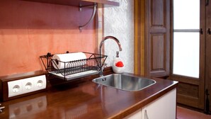 A kitchen with a built-in microwave, a sink with a faucet, and a power strip with outlets. - Charminghomesgranada Aljibe Antiguo Apartment (Granada)