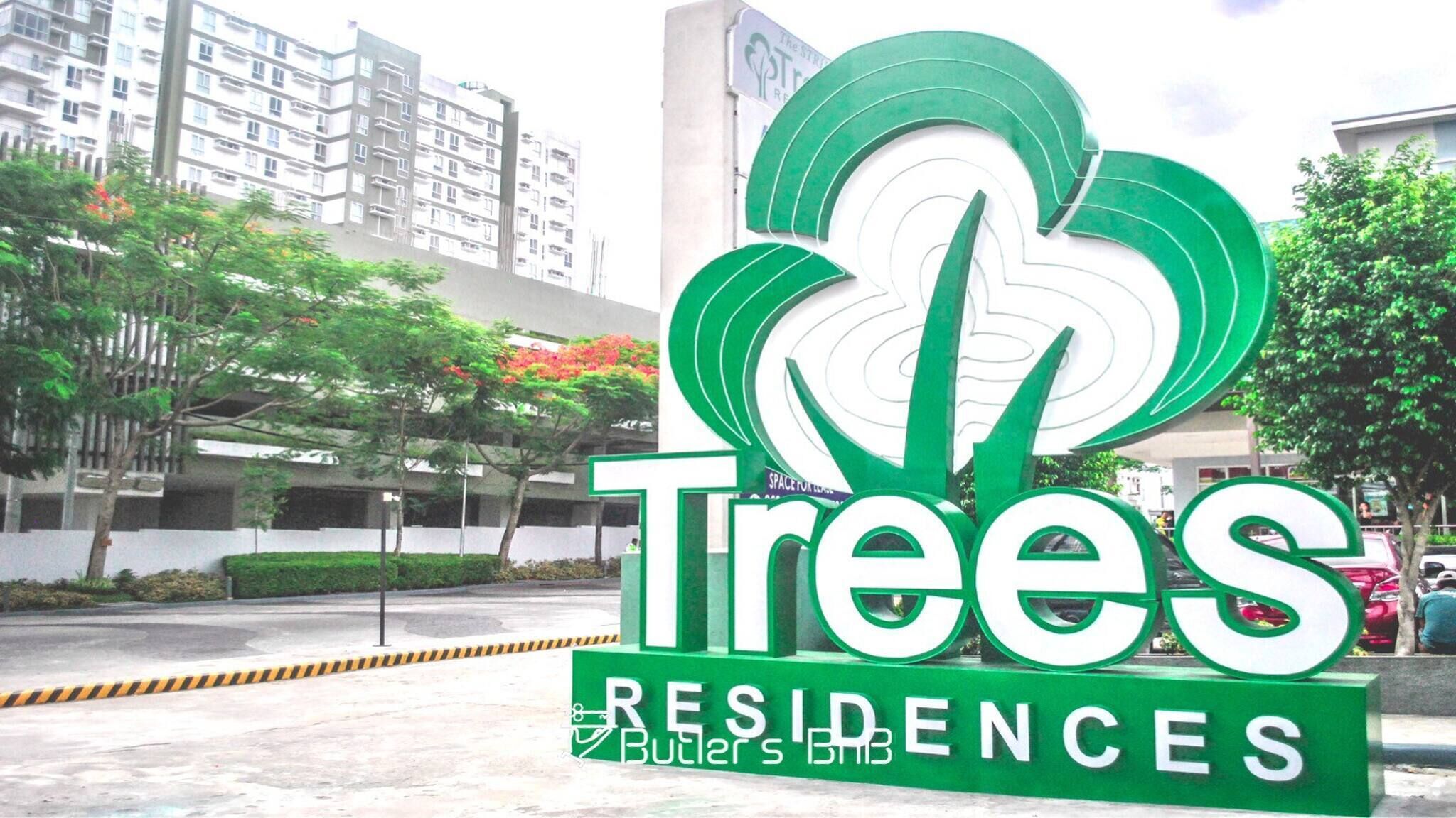 A sign for 'Trees Residences' with a stylized tree graphic.