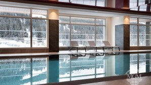An indoor swimming pool with clear glass walls reflecting a snowy forest view. - Wifi, ski-in/ski-out & foot of the slopes, view ski slopes, fitness, swimming pool, sauna, hammam (Flaine)