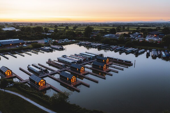 A marina with docked boats and floating houses. - Osprey (Chester)