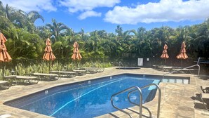 A swimming pool with lounge chairs and umbrellas, surrounded by palm trees. - Wailea Elua, #1508 2 Bedroom Condo by RedAwning (Kihei)