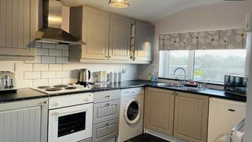 Apartment, 1 Queen Bed | Private kitchen | Fridge, microwave, oven, stovetop