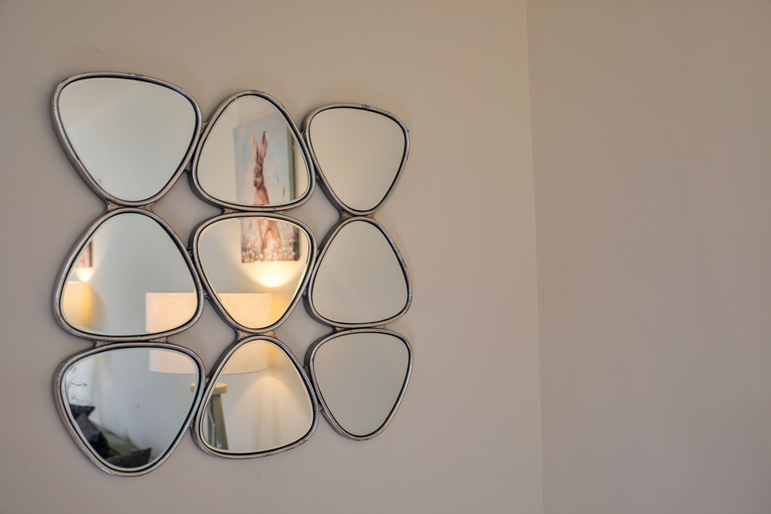 A wall-mounted mirror with an octagonal frame.