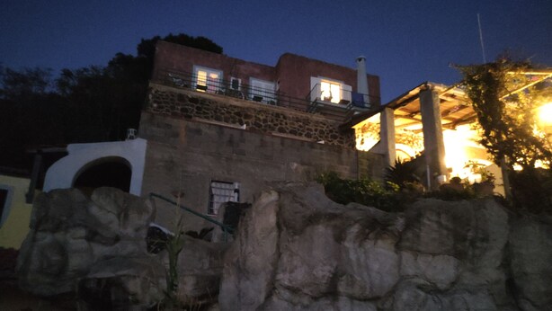 Un edifici de pedra amb un balcó i una escala que hi mena.