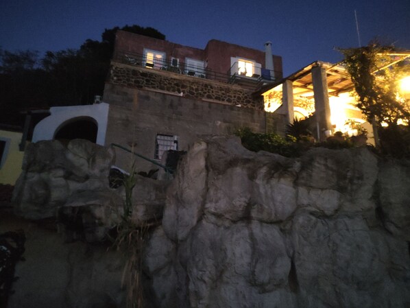 A stone building with a balcony and a staircase leading up to it. - Hotel Villa al Mare (Barano d'Ischia)
