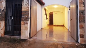 A building entrance with a stone facade, a metal gate, and an arched passageway. - Myhavelock Town Studio Apt, With Own Pvt Gate Parking in Main City (Colombo)