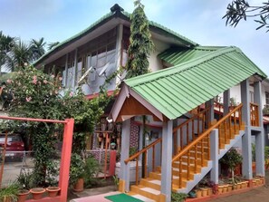 Stunning two-story residence with a balcony and potted plants, offering a charming outdoor space.
