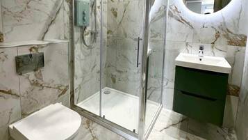 Shower, hair dryer, towels, shampoo