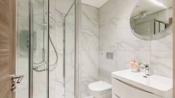 Shower, hair dryer, towels, shampoo