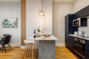 Enjoy meals in this kitchen with a central island, sink, and dining area for two.