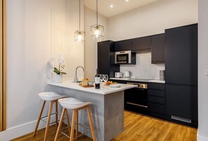 Enjoy cooking in this well-equipped kitchen with a central island, microwave, oven, and coffee maker.