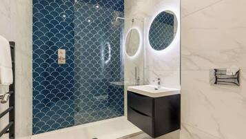 Shower, hair dryer, towels, shampoo