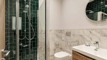 Shower, hair dryer, towels, shampoo
