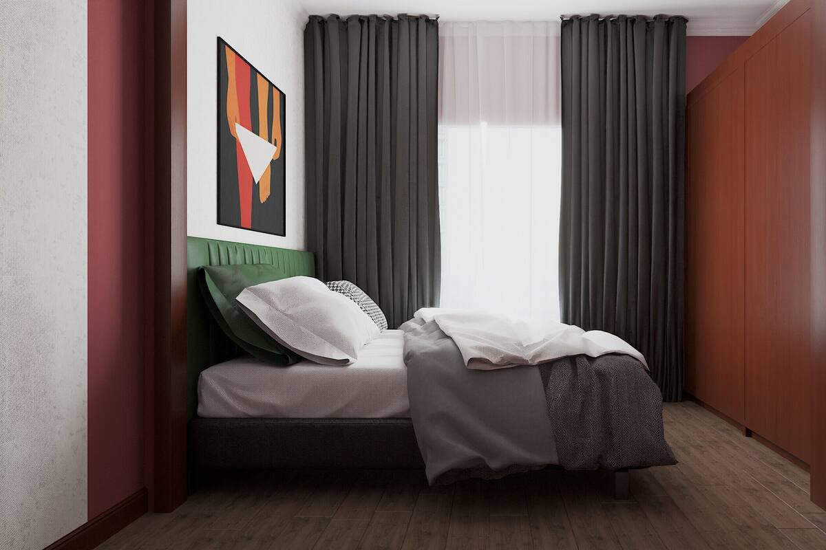A modern bedroom with a bed, green headboard, and grey curtains.