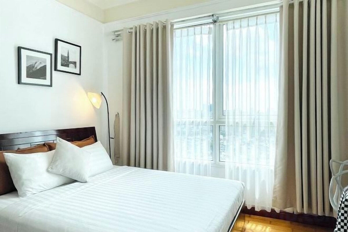 Premium bedding, laptop workspace, blackout drapes, soundproofing