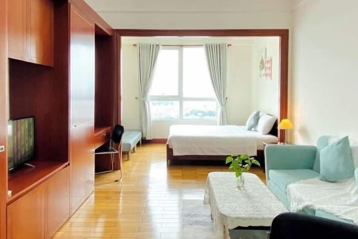 Premium bedding, laptop workspace, blackout drapes, soundproofing