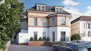 A modern two-story house with a brick facade, numbered 24, featuring a driveway and two parked cars. - NEW & Vibrant 1-Bed in Town Centre w/ Free Parking (Bournemouth)