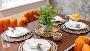 A dining table set with plates, napkins, and a potted plant. - Delightful 1-bed Studio w/ Free Parking & WiFi (Bournemouth)