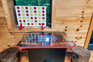 A foosball table with a clear view of the playing area and a wall-mounted game board with red and yellow discs. - 3 Min to Parkway | Private Resort Pool | Top 5%! (Pigeon Forge)