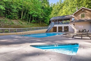 A swimming pool area with a lifeguard station, a covered seating area, and a building with a 'NO DIVING' sign. - 3 Min to Parkway | Private Resort Pool | Top 5%! (Pigeon Forge)