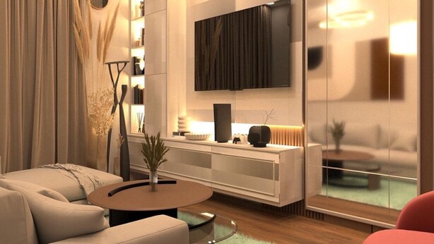 Una sala de estar moderna con un sofá, una mesa de centro y un televisor montado en la pared.