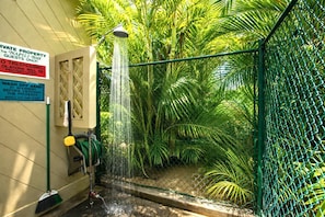 A private property with a shower, a sign indicating guests only, and a sign instructing to wash off sand before entering. - Napili Bay Resort Oceanfront Studio with Incredible Views! Complimentary Rental Car and Free Parking with 6+ Nights! | NAB-107 by KBM (Lahaina)