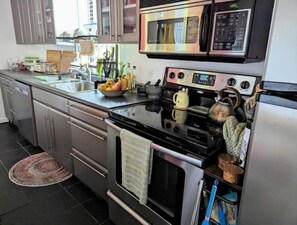 Enjoy cooking in this well-equipped kitchen with a microwave, oven, and stovetop.