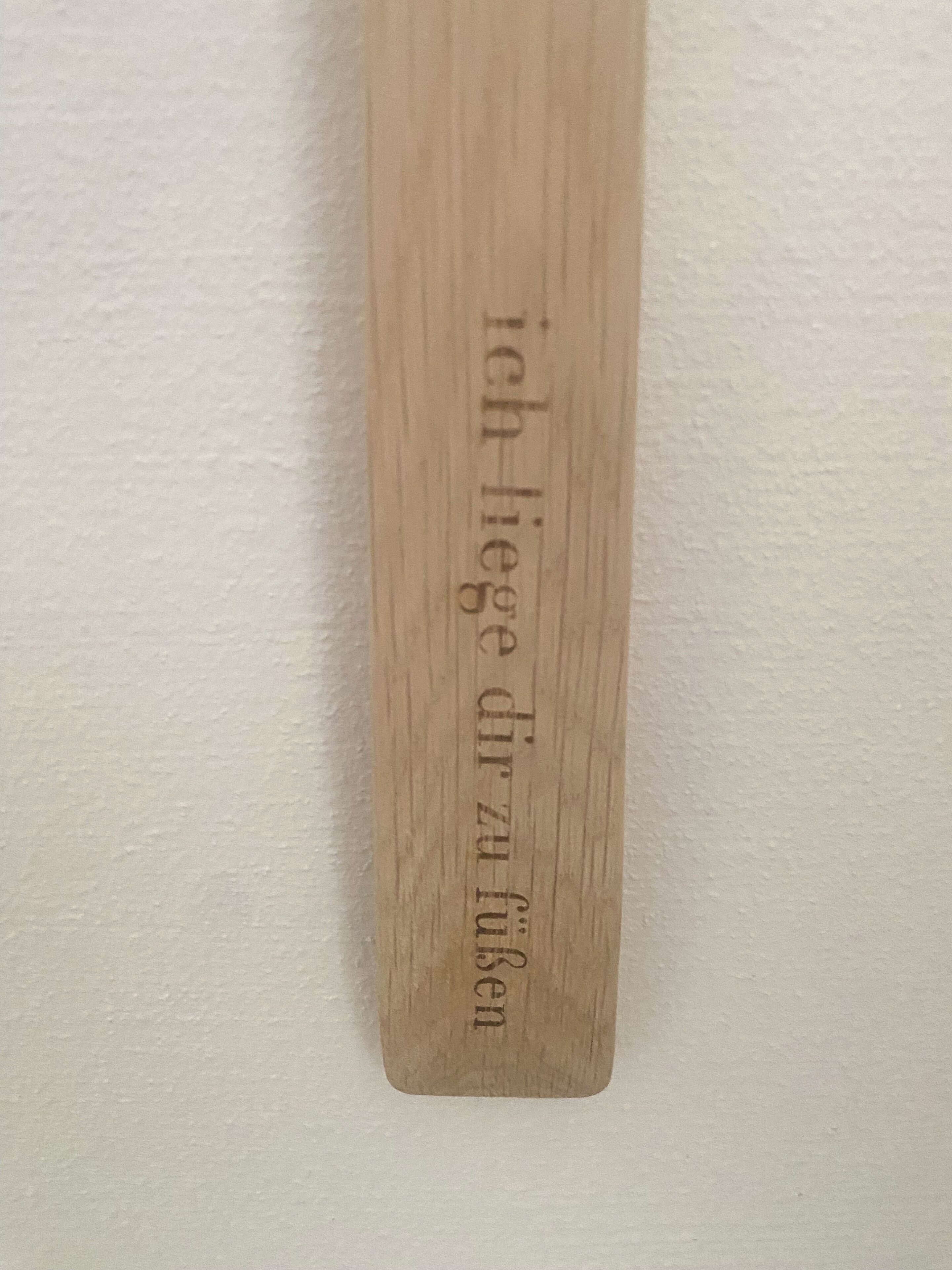 A wooden plaque with engraved text.