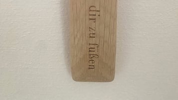 A wooden plaque with engraved text.