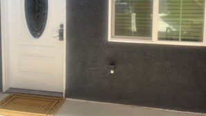A house with a white door, a large window, and a welcome mat. - Guest House in the beautiful City of Downey (Downey)