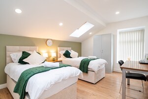 Deluxe Suite, Private Bathroom (Second floor) | Memory foam beds, desk, laptop workspace, iron/ironing board