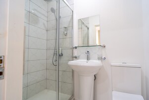 Shower, rainfall showerhead, hair dryer, towels