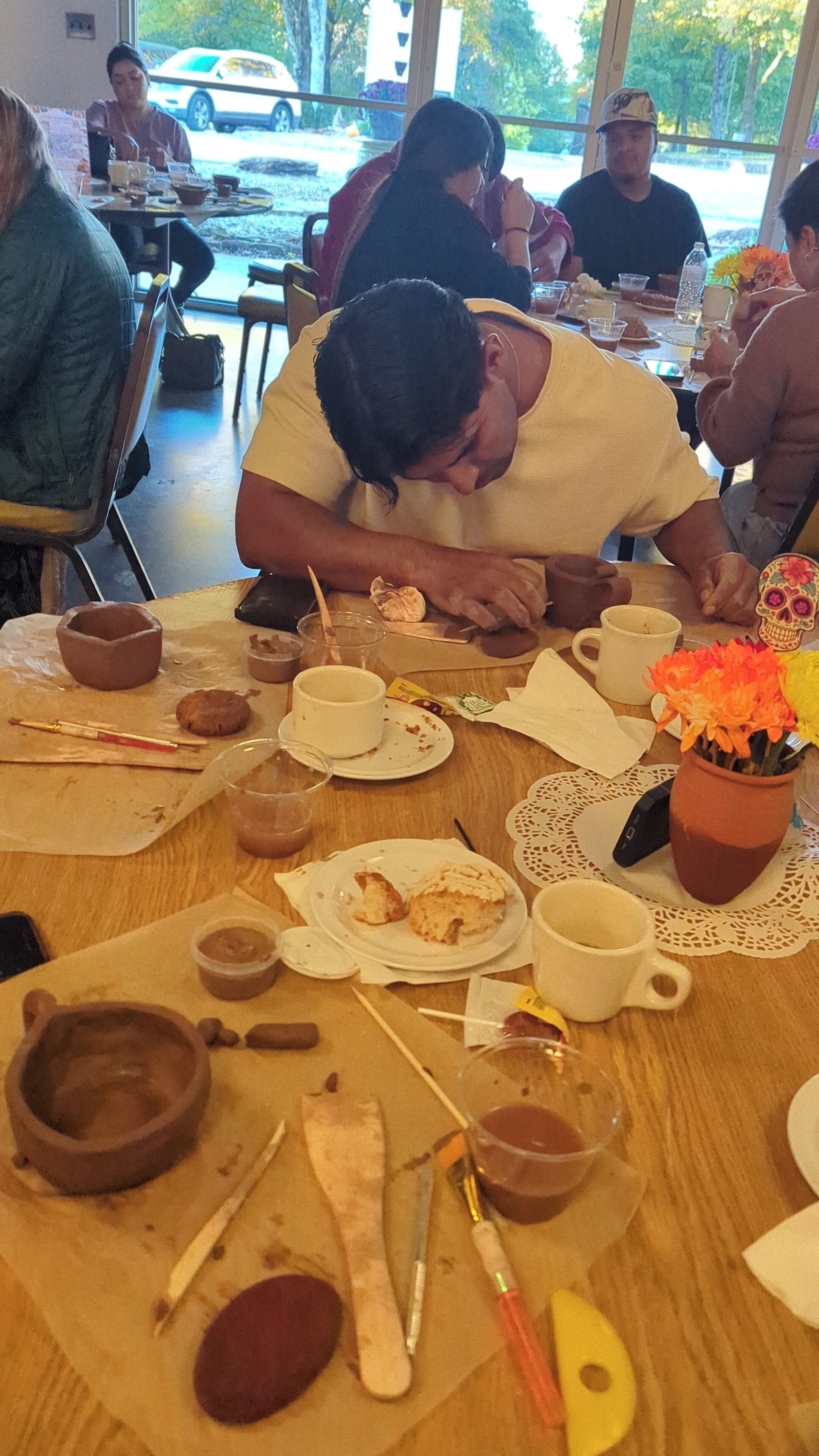 A dining area with tables, chairs, and various food items.
