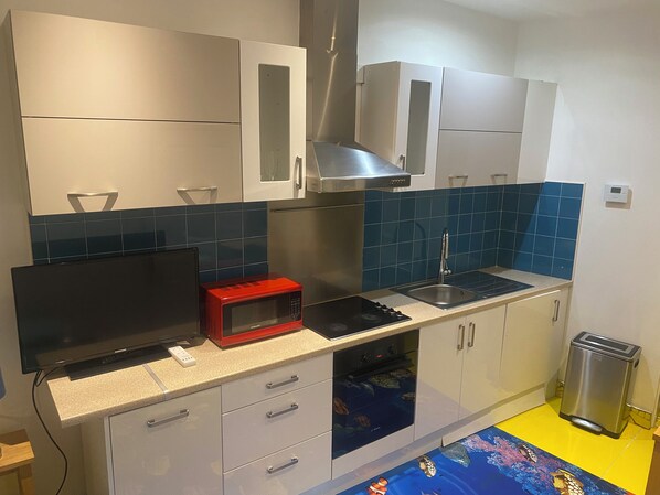 Enjoy cooking in this well-equipped kitchen with an oven, microwave, and toaster.