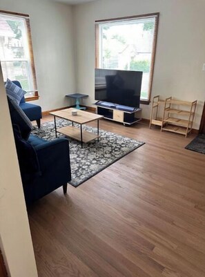 Relax in this stylish living room with a flat-screen TV, comfortable sofa, and coffee table.