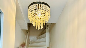 A staircase with white railings, a chandelier, and a wooden handrail. - Leiden City Centre Canal View Apartment in a 1750's building (Leiden)