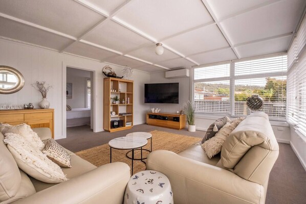 A modern living room with a sofa, coffee table, and TV.
