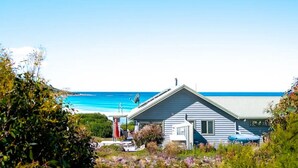 A house with a sloped roof, a satellite dish, and a view of the ocean. - Silver Moon at Half Moon Bay - Paradise! (Glamorgan-Spring Bay)