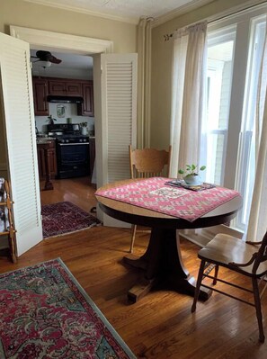 Enjoy meals in this cozy dining area with a round table and comfortable seating for two.
