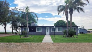 A single-story house with a front porch, a driveway, and a lawn. - Beautiful peaceful quiet country living 

 (Holtville)