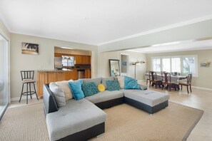 Relax in this spacious living area with a large L-shaped sofa and dining table.