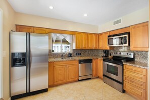 Enjoy cooking in this well-equipped kitchen with a refrigerator, dishwasher, microwave, and oven.