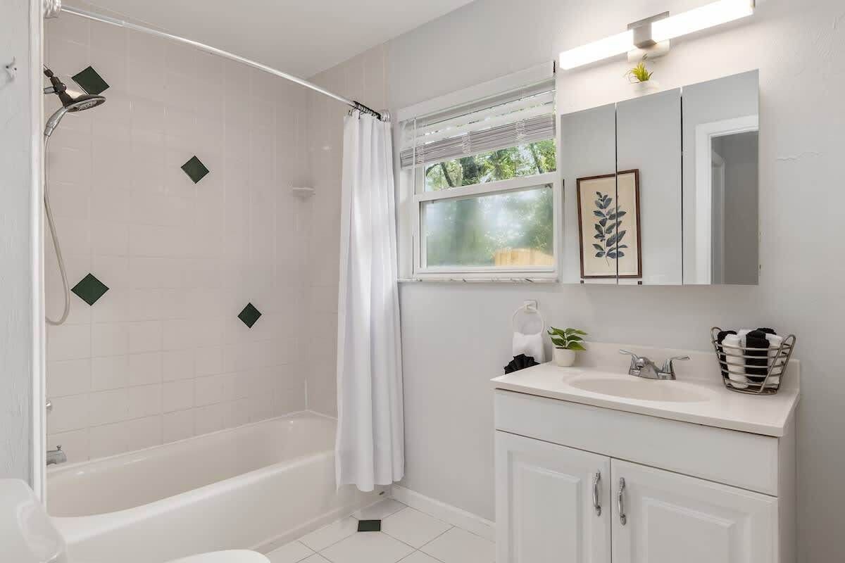 A modern bathroom with a shower, toilet, and sink.